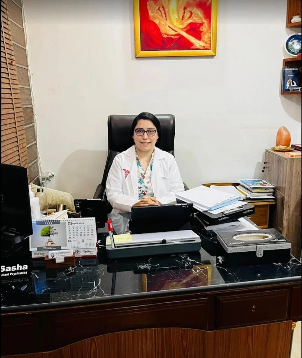 Dr. Sasha Raikhy, psychiatrist, seated at her desk in the clinic